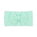 Soft mint green baby nylon headband with a large decorative fabric bow on plain white background - Light Green