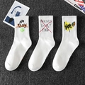 Three-pack white crew socks with colorful street graffiti prints on gray background - One Size / White Printed Series (14-07-05)
