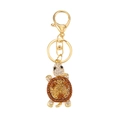 Golden turtle keychain with vibrant orange and yellow rhinestones on white background - Champagne