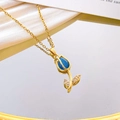 Golden tulip necklace featuring a blue teardrop stone and zircon-encrusted leaves - Blue Cat Eye Necklace / Gold