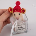Detail of red knitted hamster hat with golden trim and pompom for small pets - Ancient Official Hat