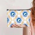 Detail showing hand-held makeup bag with blue evil eye print and zipper closure - Hand Geometric Texture (jiaying0036)