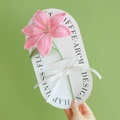 Handmade pink crochet lily flower bookmark with green stem and white silk ribbon detail - Lily - Pink