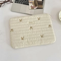 Close-up of cream quilted laptop sleeve with cute rabbit embroidery and brand woven label - 11" / Baby Cotton Rabbit
