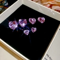 Detailed close-up of heart-shaped purple zirconia crystals on black velvet lining - 5# Silver Pin Purple Heart Gem 6-Piece Set
