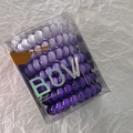 Detail of nine purple gradient spiral hair ties inside a clear plastic gift box - Purple