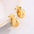 Polished gold teardrop earrings in a minimalist hollow design resting on a white ceramic plate - Large Gold (32mm*18mm)