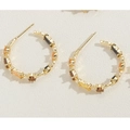 Detail of 14K gold C-shaped earrings with hammered texture and multi-colored zircons - Coffee Zirconia C-Shaped Style (ES2283) / Gold