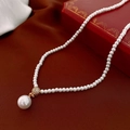 Close-up of pearl necklace with gold pave crystal connector on red velvet background - 21# Necklace-Gold-Sphere Rhinestone