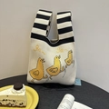 Cream knitted tote bag with yellow duck embroidery and black and white striped handles - Yellow Chick