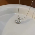 Detailed view of silver crescent moon pendant with inlaid zircon on fine chain - Silver