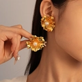 Close-up of vintage golden flower earrings with white pearl and textured metal petals - Style 13-Gold Flower Textured Pearl Studs (Silver Earring Post)