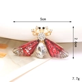 Detailed macro shot of a jewel-encrusted bee brooch with dimensions 5cm x 2.6cm - Gem Bee-Red