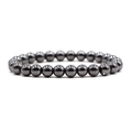 Macro-opname van 8mm gepolijste hematiet kralenarmband met hoogglans metalen afwerking - Hematiet