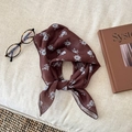 Deep brown chiffon scarf with light floral print, elegantly knotted on a beige linen background - Dark Brown Floral Style 4