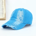 Close-up of a distressed bright blue cotton baseball cap with vintage washed ripped details - Adjustable / Sky Blue