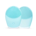 Light blue silicone facial cleansing brush with dual-sided bristles and power button - Blue