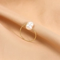 Elegant gold open ring featuring two white pearls on a twisted textured band - Natural White