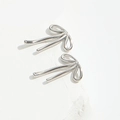 Minimalist silver bow knot stud earrings with a polished metallic finish on white background - M / Silver - Medium