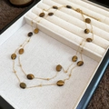 Detail of layered tiger eye necklace with gold beads on a beige jewelry tray - Oval Tiger Eye Necklace / Necklace-Gold-Brown-Oval