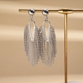 Detailed view of silver-tone tassel earrings featuring hollow geometric shapes and beaded chains - Silver (925 Sterling Silver Earring Post)