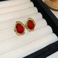 Close-up of vintage resin earrings with red stones and gold lava frames on velvet - Water Drop Stud / Red