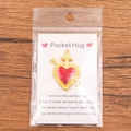 Pocket Hug Heart charm with red cross on wood background with gift card packaging - Gold Cross Heart