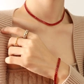 Retro gold jewelry set with red zircon necklace and checkered ring on a model - Red Zirconia Necklace