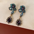 Detail of vintage snake-shaped golden earrings with colorful crystals and teardrop pendants - Snake Drop Earrings (Silver Pin-Purple-Blue)