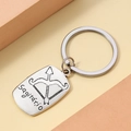 Detailed close-up of polished silver Sagittarius keychain with bow icon and engraving - Sagittarius