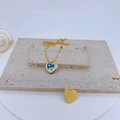 Detailed shot of a gold-plated heart pendant with blue and white enamel Tai Chi motif - Blue & White Tai Chi Heart