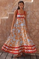 Detail of bohemian floral maxi dress featuring red rickrack trim and cotton linen texture - Orange Background Floral
