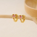 Detailed view of gold heart earrings with zircon flowers hanging on a wooden branch - EH411017