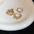 Macro detail of three gold irregular textured rings with liquid metal ripple design - Style 7 (Set of 3)