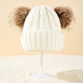 Beige cable knit baby beanie featuring two brown faux fur pom poms for winter warmth - Adult White