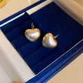 Close-up of matte gold heart drop earrings resting in a premium navy velvet jewelry box - Ear Hook - Gold