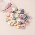 Detailed top view of mini macaron hair claws in various colors on a beige background - Rectangular Style / Bulk Packaging / Macaron Series