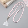 Pink and white braided crossbody phone lanyard with metal clasp and tether tab on desk - 10mm Width / Pink