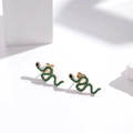 Chic gold-plated snake stud earrings with green micro-pave crystals on white stand - Gold / Green & Black Zircon