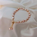 Baroque pink pearl bracelet with gold hardware on elegant white silk background - Bracelet-Pink (Freshwater Pearl)
