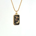 Macro detail of gold tarot card pendant with moon star motif and gold twisted chain - Tarot Card E
