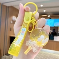 Yellow milk tea bear keychain with liquid sand bottle and bow charm accessory - Fresh Lollipop - Yellow
