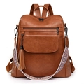 Detail of brown PU leather backpack featuring fringe charm and colorful woven shoulder strap - Yellow Brown
