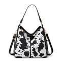 Detail of cow print tote bag with black handles, gold hardware, and tassel zipper puller - Single Piece / Cow Print Black