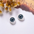 Detailed close-up of 12x16mm blue-grey acrylic doll eyes with realistic spiral texture - Grey Stripe