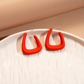 Macro detail of red matte acrylic geometric hoop earrings on a ceramic dish - Red Square (Silver Earring Post)
