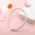 Simple white fabric wrapped headband shown on a pink surface with decorative props - White