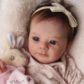 Realistic 18-inch newborn baby doll with brown hair, lace headband, and plush rabbit toy - Pink Floral