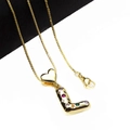 Detailed close-up of golden letter L pendant with colorful zircon stones and heart link - Pendant with Necklace / L