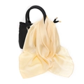 Close-up of cream satin silk scarf tied on a black leather handbag handle as a stylish accessory - One Size / Faux Silk Satin / Beige